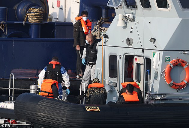 Migrants were seen being escorted off a Border Force patrol boat in Dover on Thursday, on the tenth day of arrivals across The Channel