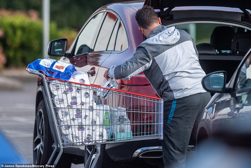 As customers flooded social media with pictures of empty aisles, one shopper declared: 'It's happening again' (pictured: Costco customer in Manchester)