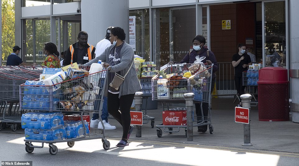 Shoppers left with stacked trollies, with one person at Costco Chingford leaving with multiple packs of bottled water