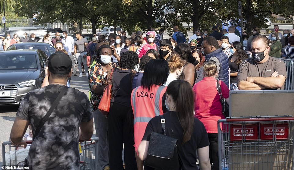 Extra security was on hand to police the growing queues as shoppers waited to get inside the Chingford Costco in north London to pick up essential items