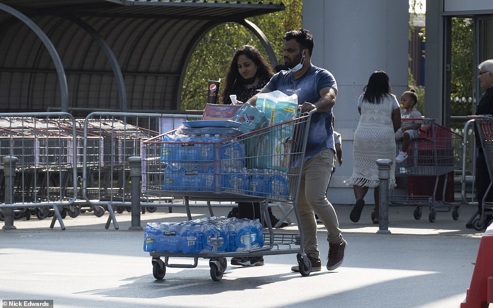 Bottled water was among the list of fast selling items, with this couple leaving the Chingford Costco with trolley-loads