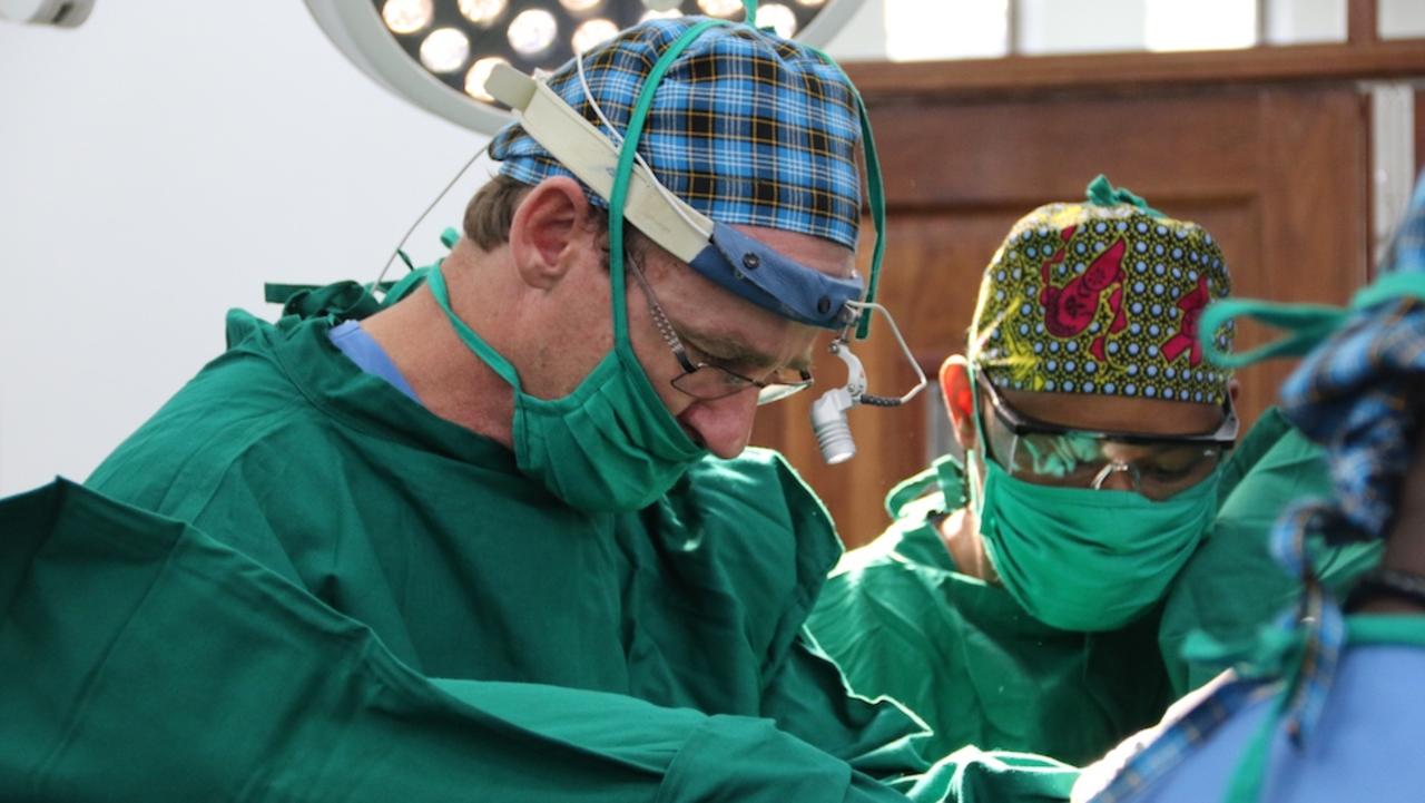 Australian surgeon Dr Andrew Browning AM operating in Africa, has made numerous trips to the continent to help. Picture: Supplied